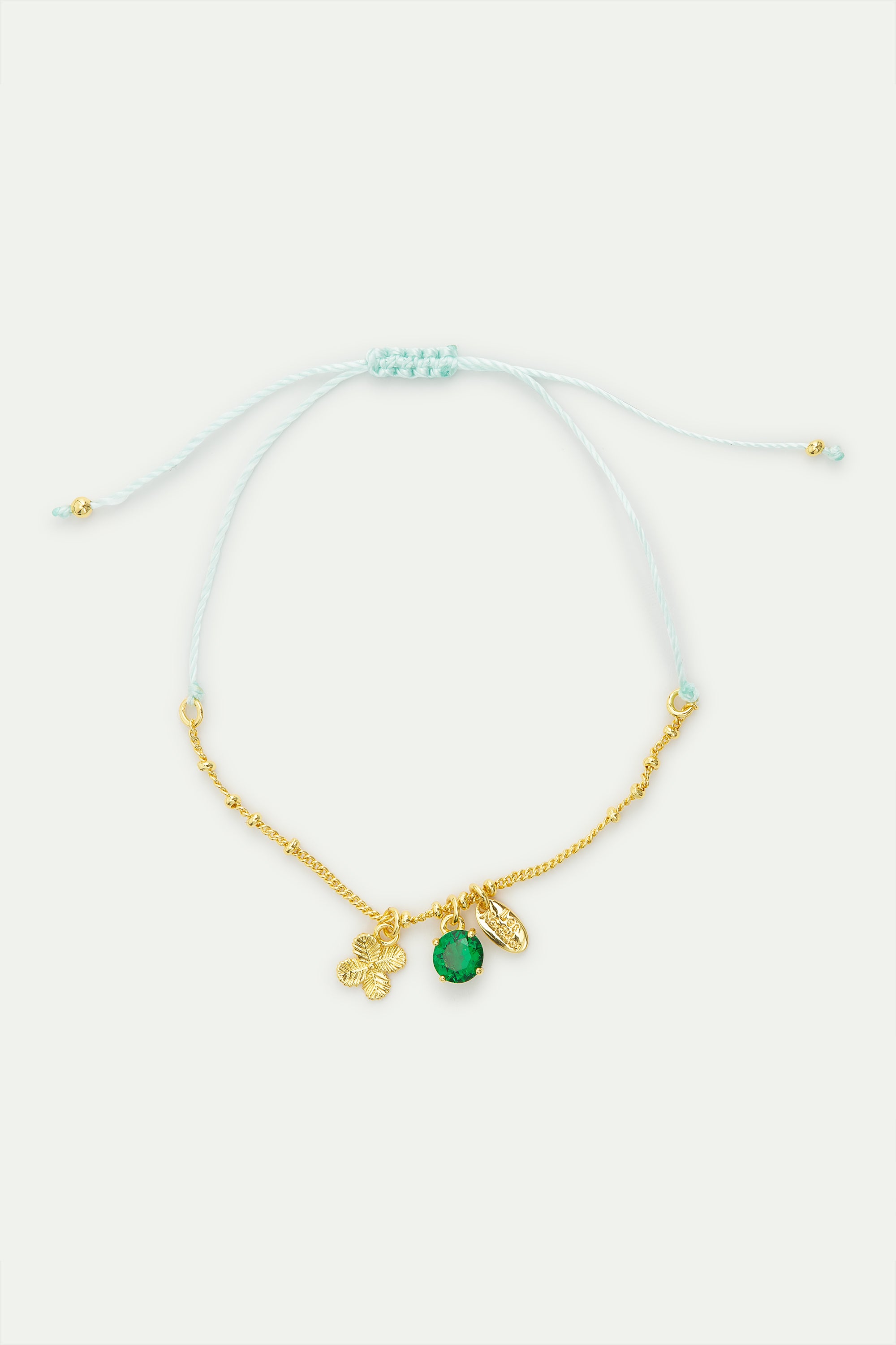 Fine bracelet with gold four-leaf clover and green faceted crystal