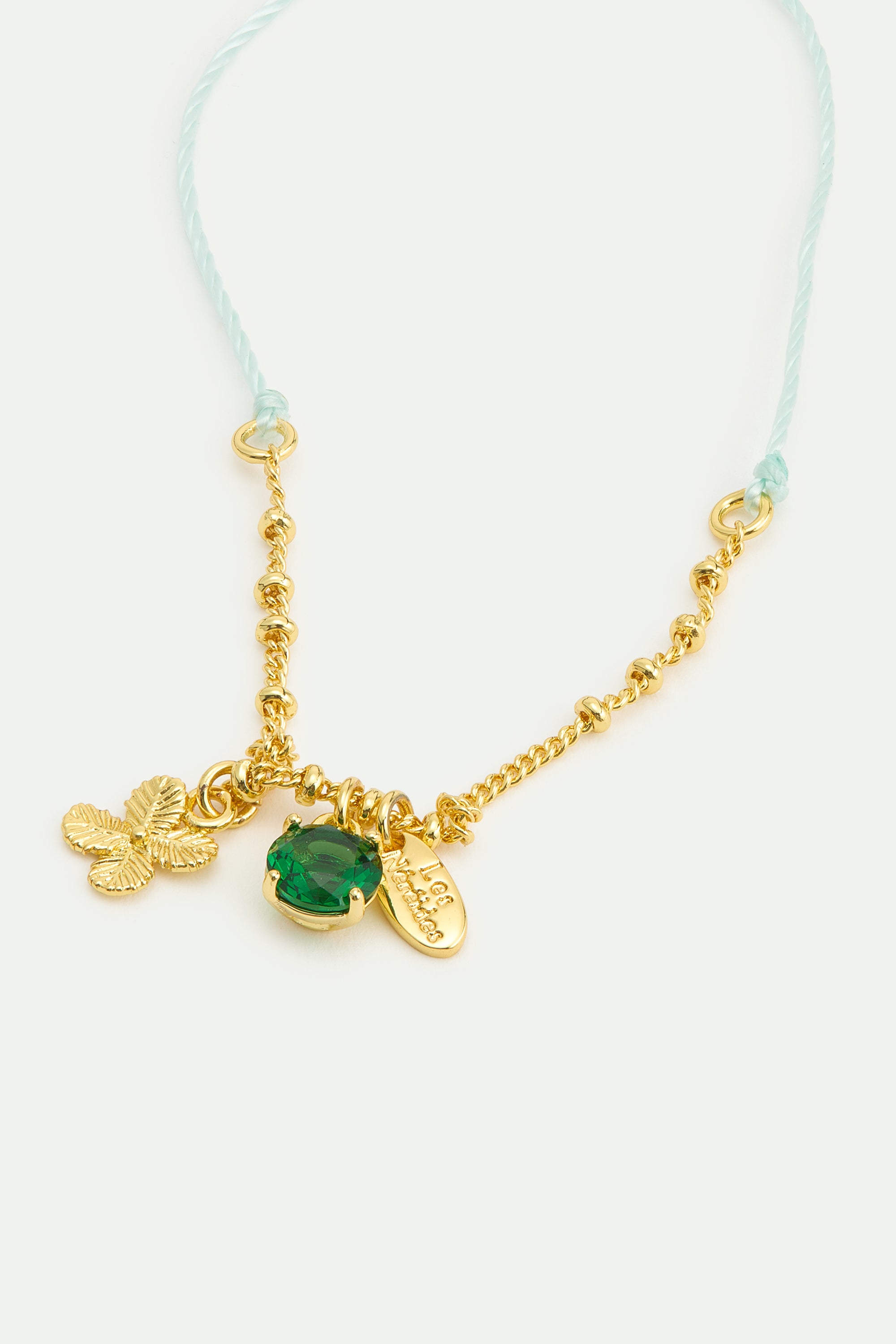 Fine bracelet with gold four-leaf clover and green faceted crystal