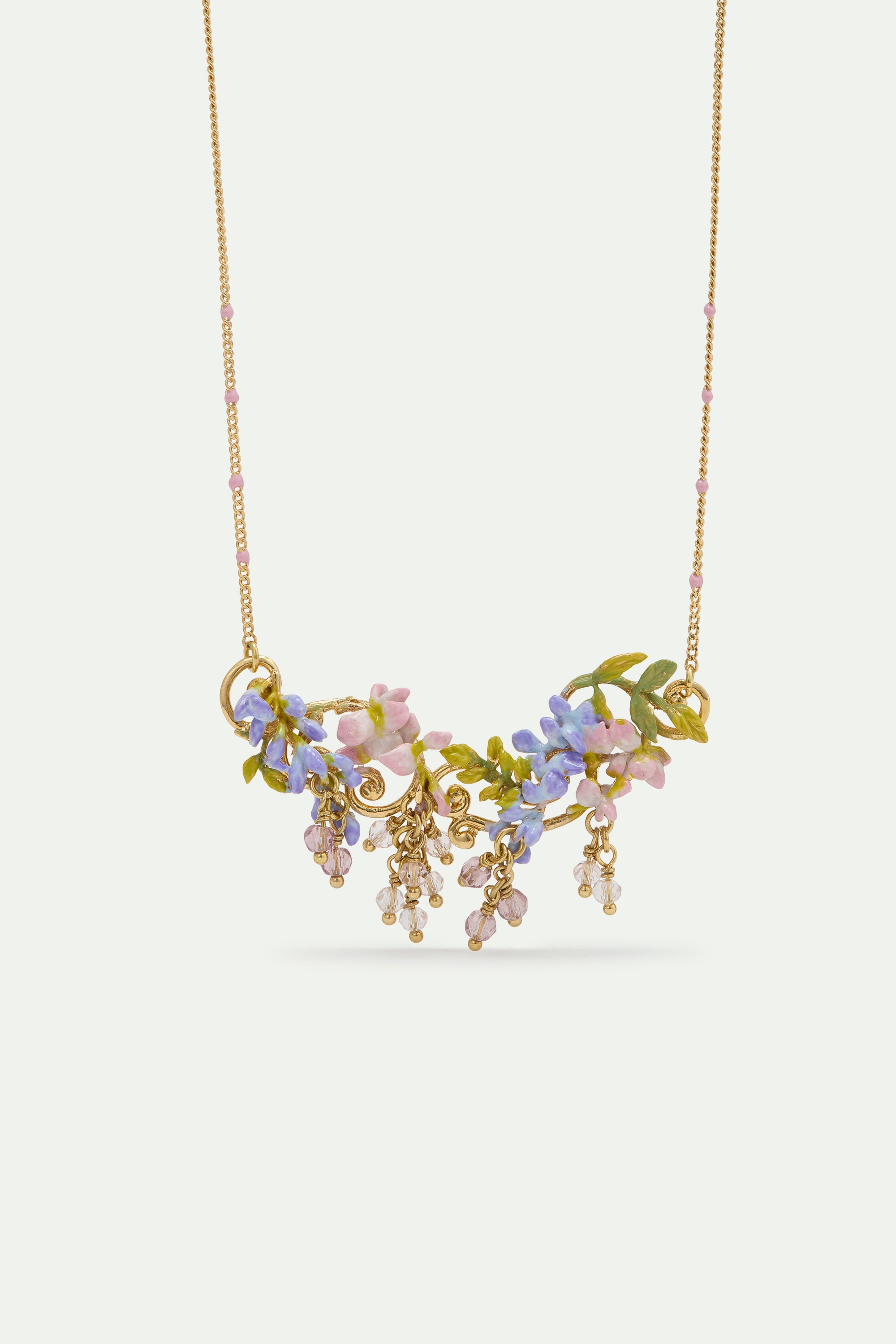 Statement necklace with pink and purple wisteria on a golden arabesque, adorned with ivy and dangling faceted pink and white crystal beads