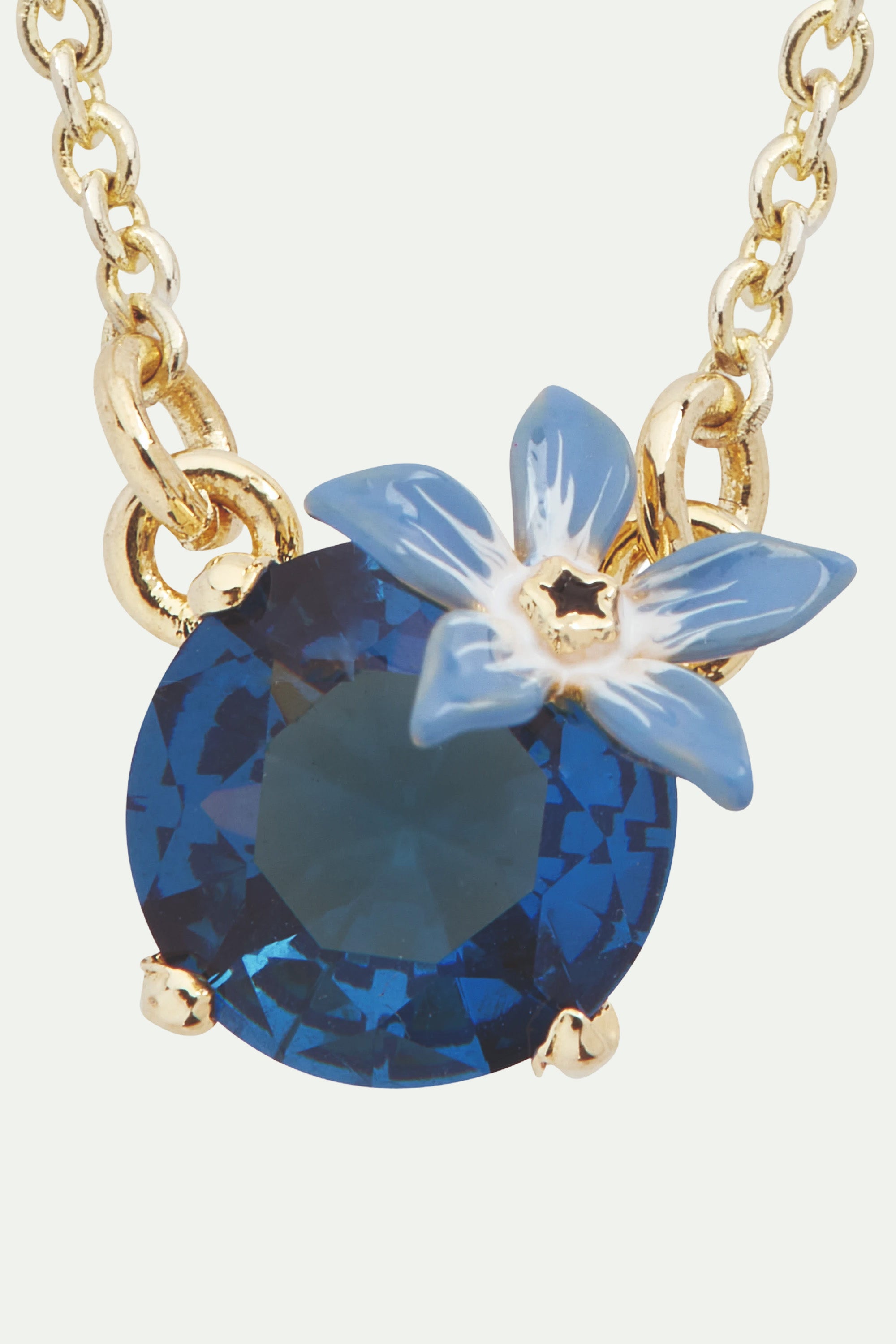 Collier pendentif fleur bleue et verre facetté rond