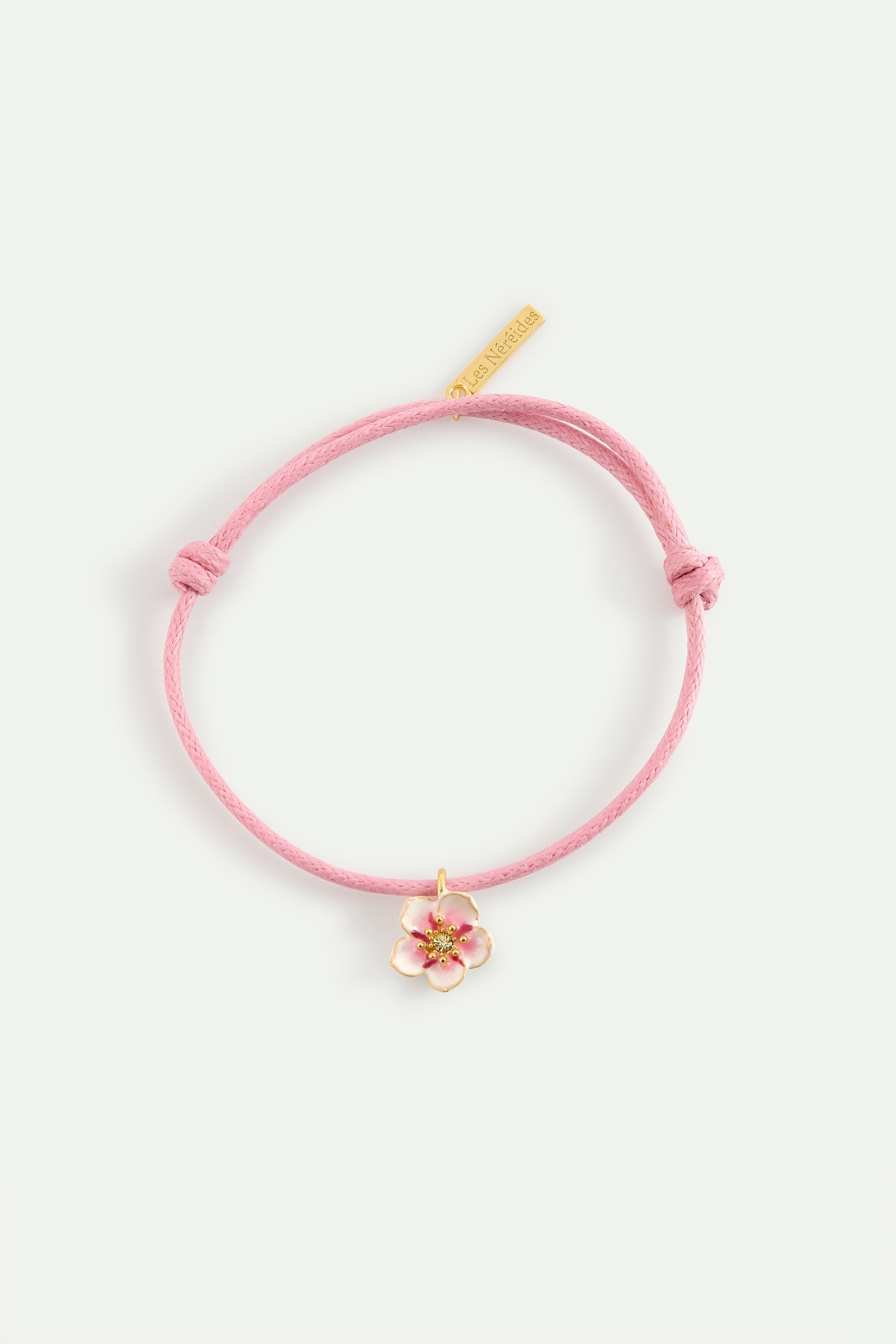 Pink thread bracelet with a tiny white cherry blossom